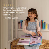 Child holding a book with a shelf of books in the background. ViraGuard Seasonal Herbal support